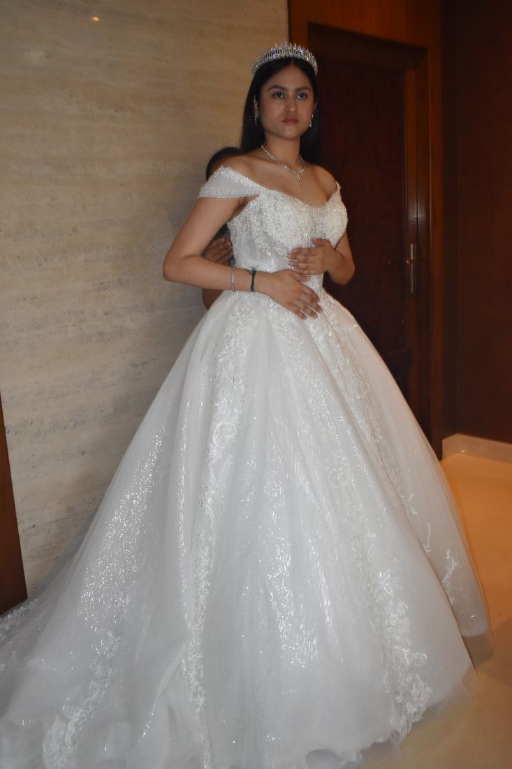 Bride wearing a crystal crown with a sparkling tulle ball gown