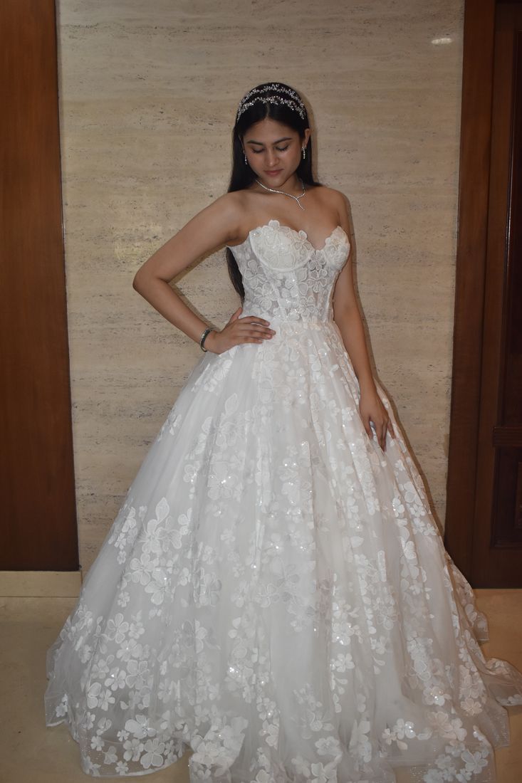 Strapless ball gown covered in three-dimensional floral appliqué